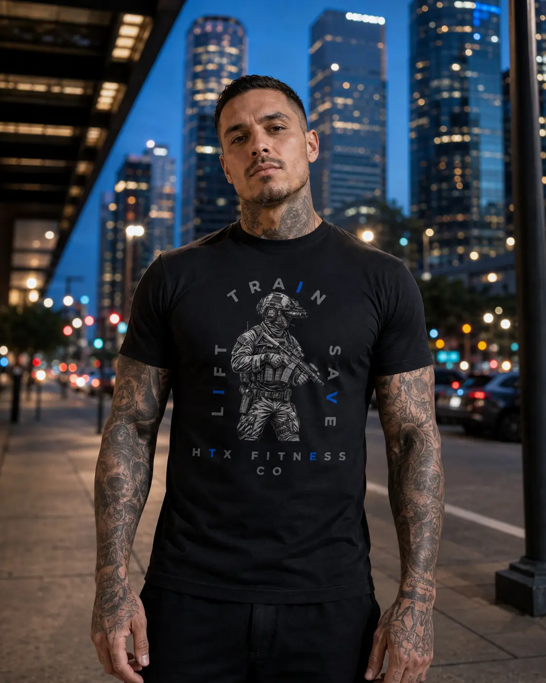Model wearing an HTX Fitness Co. tee on a Houston street at dusk